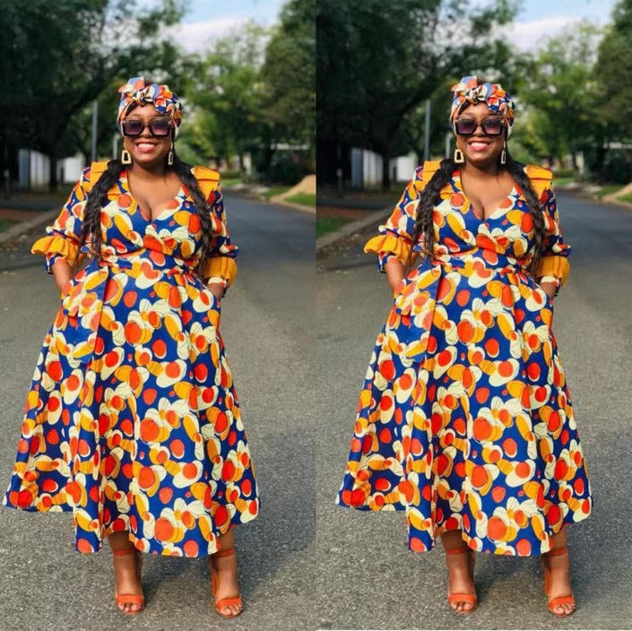 Ruffle sleeve dress in blue with multicolor geometric circle motif and tiered skirt