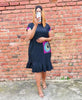 Black pleated-hem dress with colorful peacock-pattern pocket panel and short sleeves