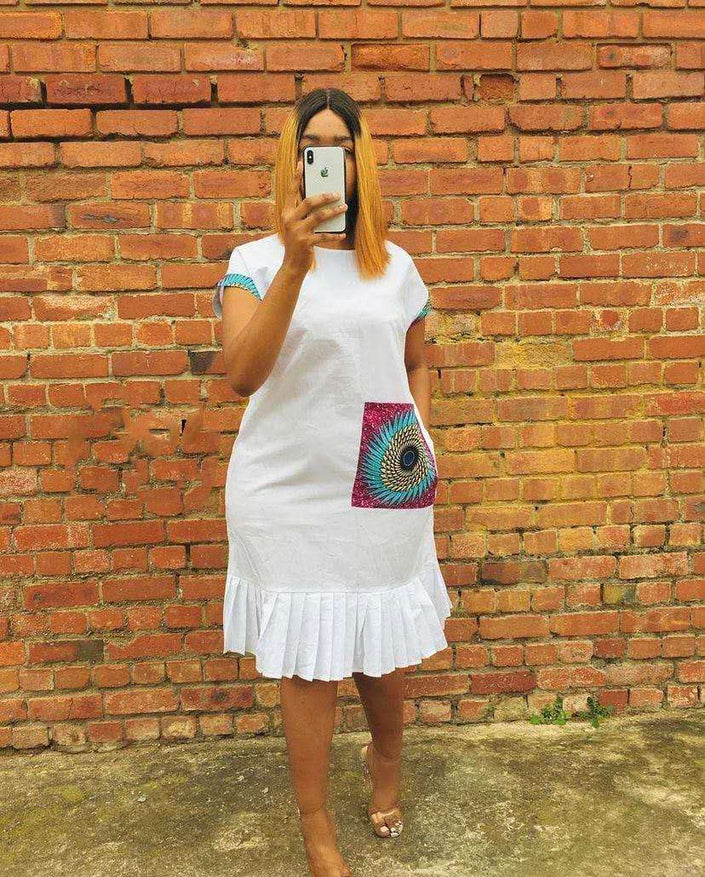 White pleated-hem dress with colorful peacock-pattern pocket panel and short sleeves