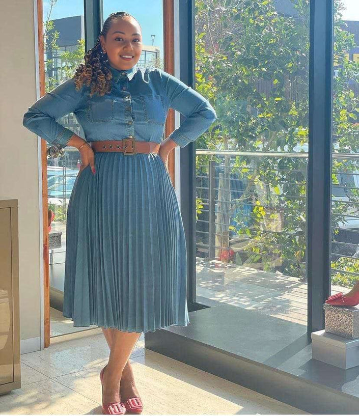 Blue denim midi dress with pleated high-waist skirt, long sleeves, button front.