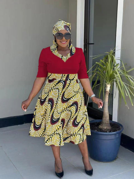 Maroon midi pleated African print dress with black and gold swirl pattern