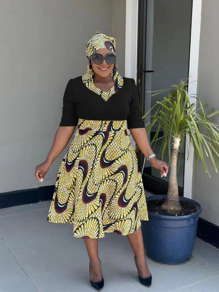 Black midi pleated African print dress with gold and maroon swirl pattern