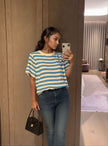Light blue and cream striped knit top with short sleeves and crew neckline