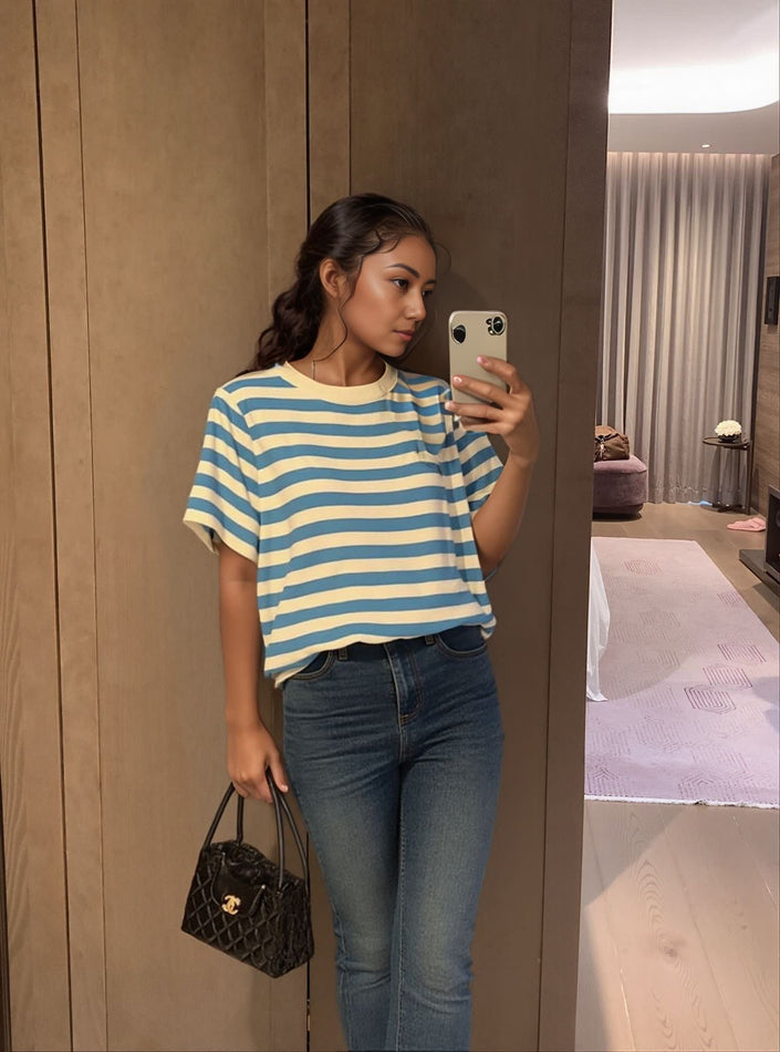 Light blue and cream striped knit top with short sleeves and crew neckline