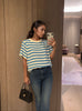 Light blue and cream striped knit top with short sleeves and crew neckline