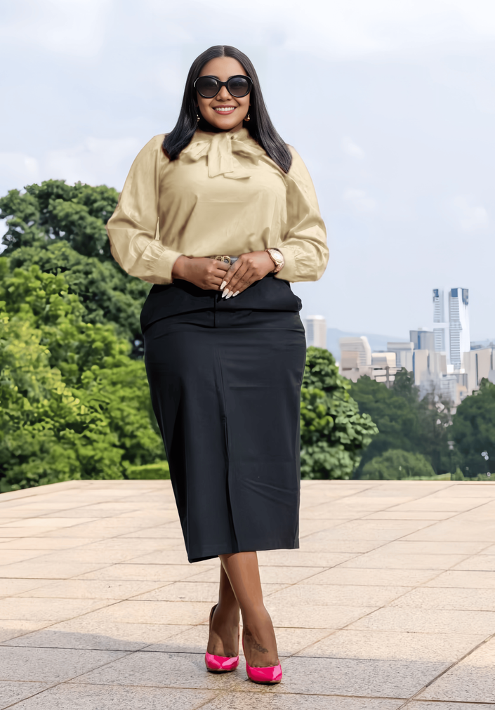 Beige long-sleeve bow-tie blouse with tied neck and gathered cuffs.