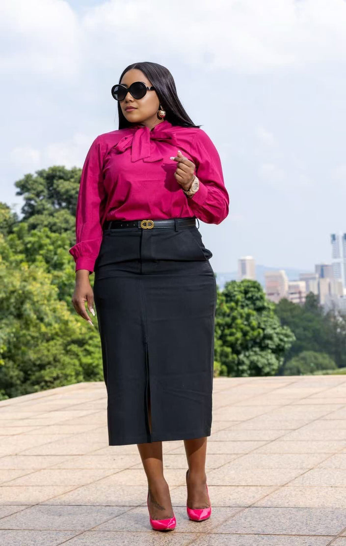 Fuchsia long-sleeve bow-tie blouse with tied neck and gathered cuffs.