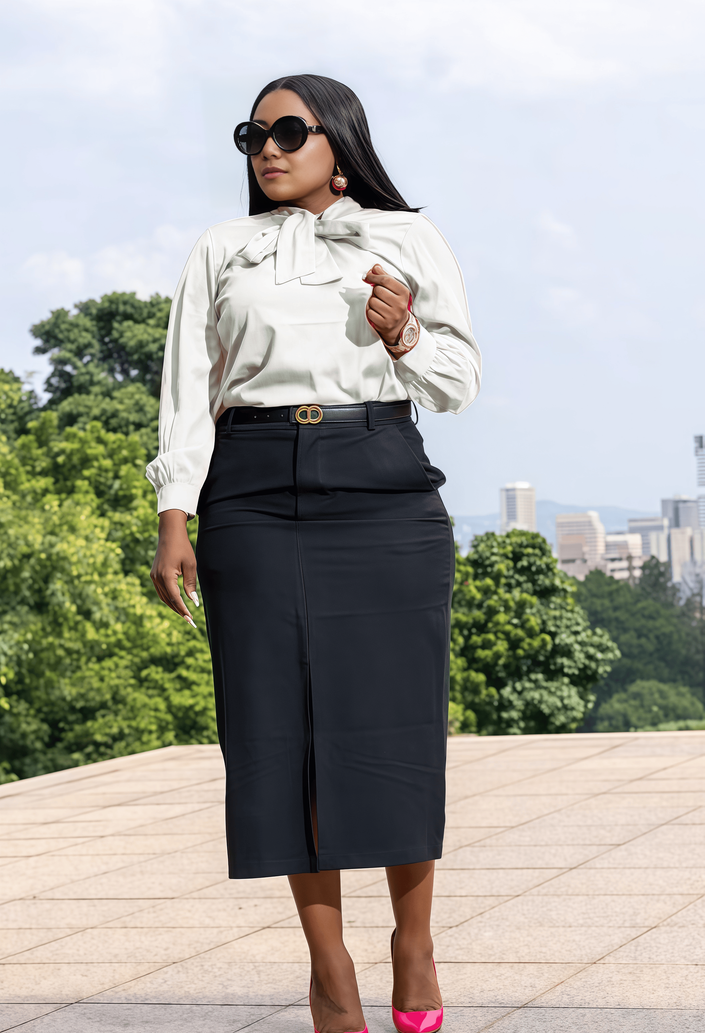 White long-sleeve bow-tie blouse with tied bow collar and gathered cuffs.