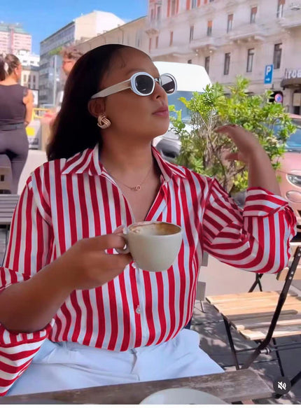 Red and white long-sleeve striped shirt with pointed collar and button front.