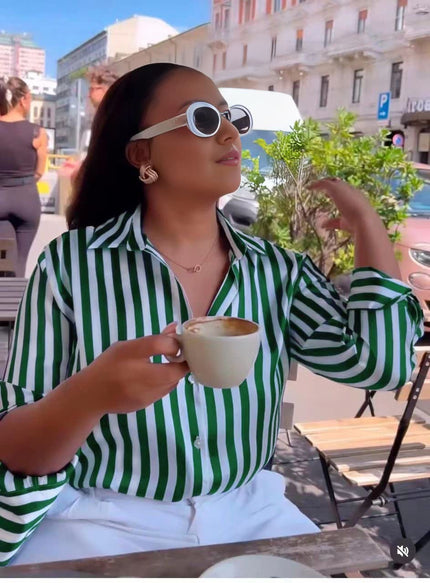 Green and white long-sleeve striped shirt with pointed collar and button front.