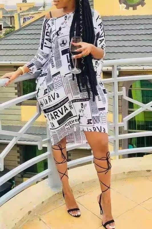 Newspaper print dress, white with black typography, V-neck and short hem