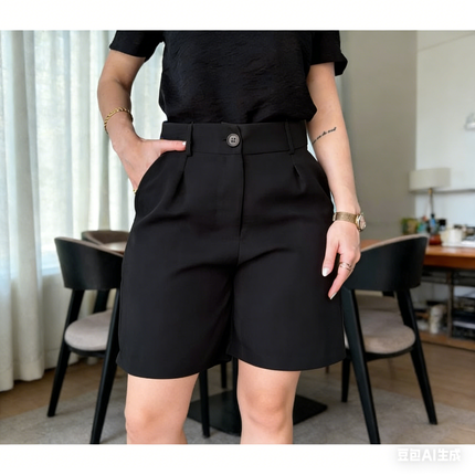 Black pleated high-waist shorts, button detail at waistband
