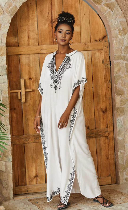 Loose-fit white maxi dress with black embroidered V-neck and short sleeves