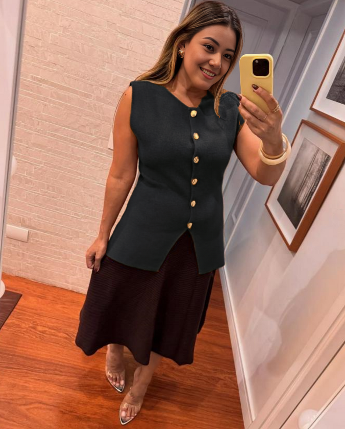 Black sleeveless top with gold buttons and center slit detail