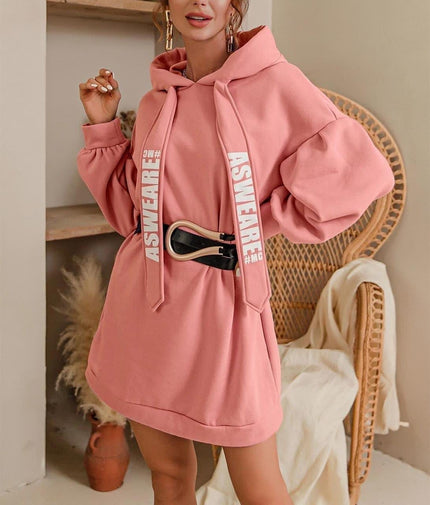 Oversized hoodie dress in light pink with front pocket and drawstring hood.