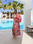 Pink abstract-print wrap maxi dress with long sleeves, V-neck, and side slit