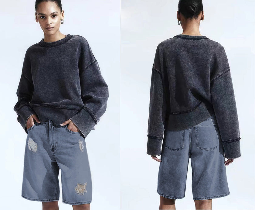 Distressed knee-length loose-fit denim shorts with rips at knees