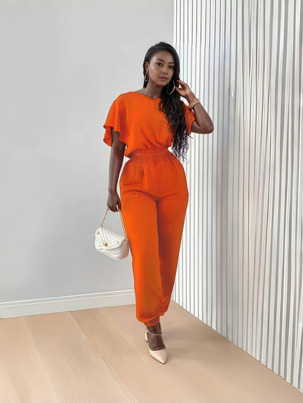 Orange-red stretch twin set with short-sleeve top and tapered jogger pants, tie waist