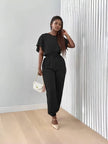 Black stretch twin set with short-sleeve top and tapered jogger pants, tie waist