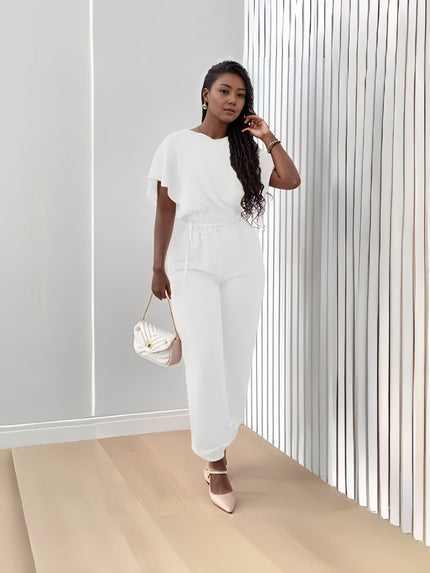 White stretch twin set with short-sleeve top and tapered jogger pants, tie waist