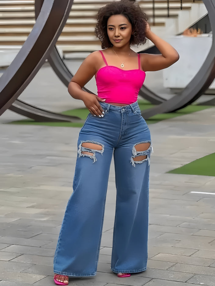 High-waist blue flared jeans with knee rips and frayed distress, wide leg fit