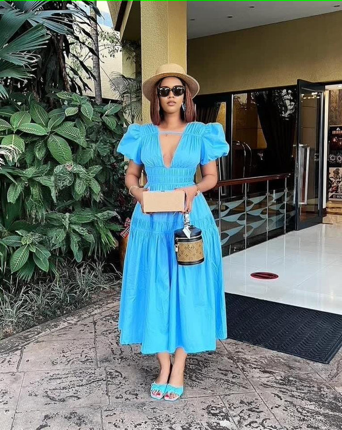 Sky-blue puff sleeve tiered maxi dress with deep V-neck and elastic bodice