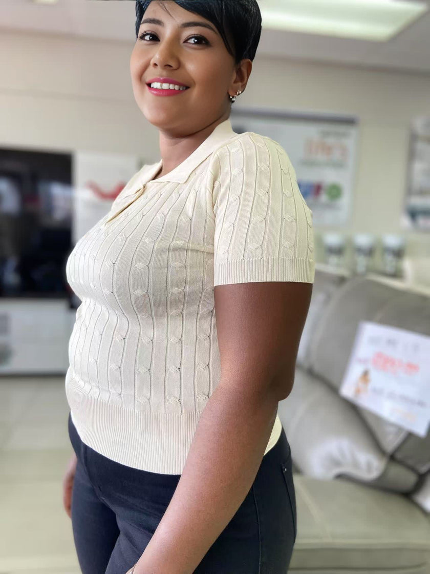 Cream cable-knit polo top with short sleeves and button placket