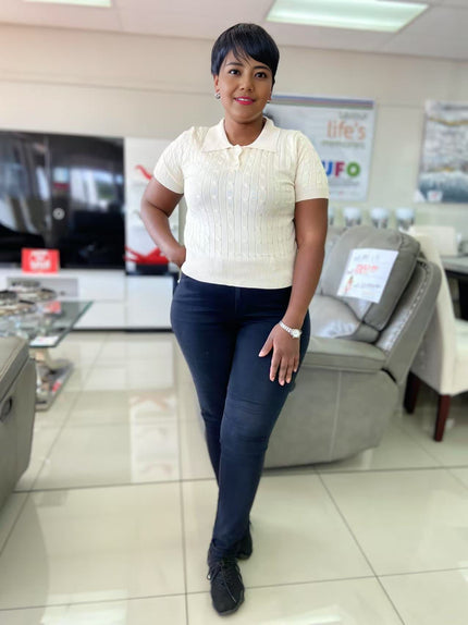 Cream cable-knit polo top with short sleeves and button placket
