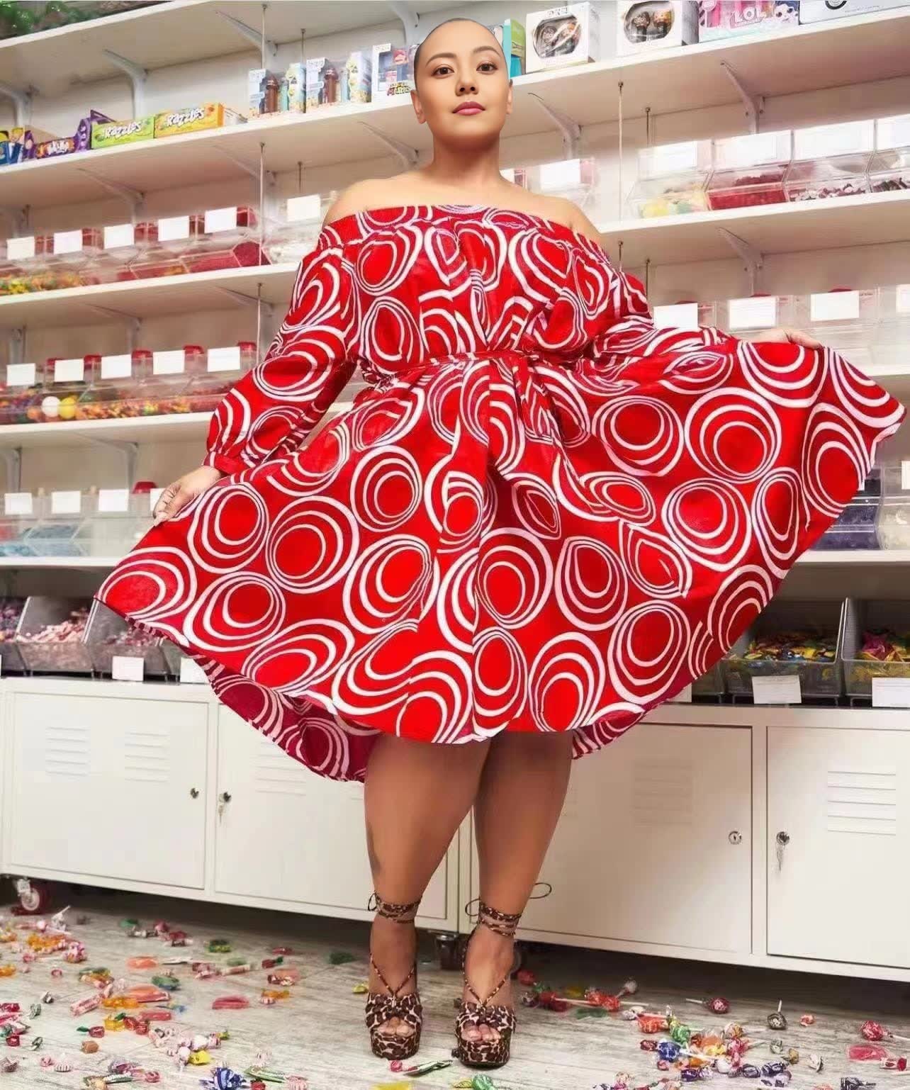 Red off-shoulder puff sleeve midi dress with white circular pattern, wide A-line skirt.