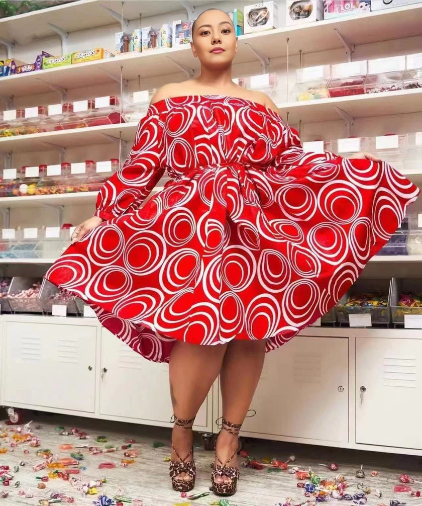 Red off-shoulder puff sleeve midi dress with white circular pattern, wide A-line skirt.
