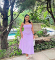 Light-purple midi dress with spaghetti straps, ruched top, and adjustable drawstring waist