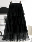 Black layered pleated skirt with elastic waistband and tiered ruffles