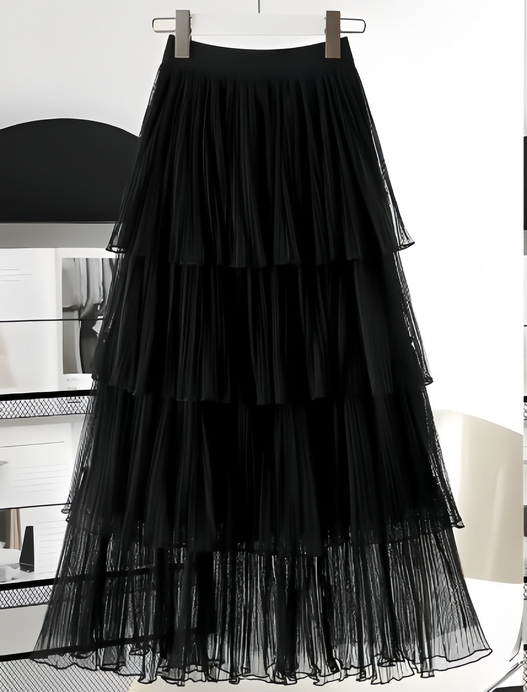 Black layered pleated skirt with elastic waistband and tiered ruffles