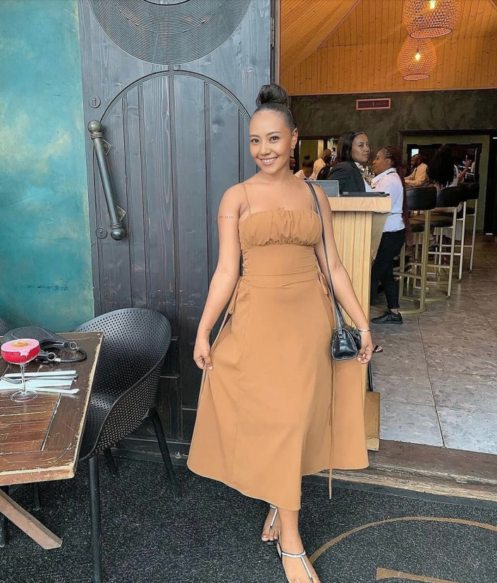 Tan midi dress with spaghetti straps, ruched bust, and adjustable drawstring waist ties