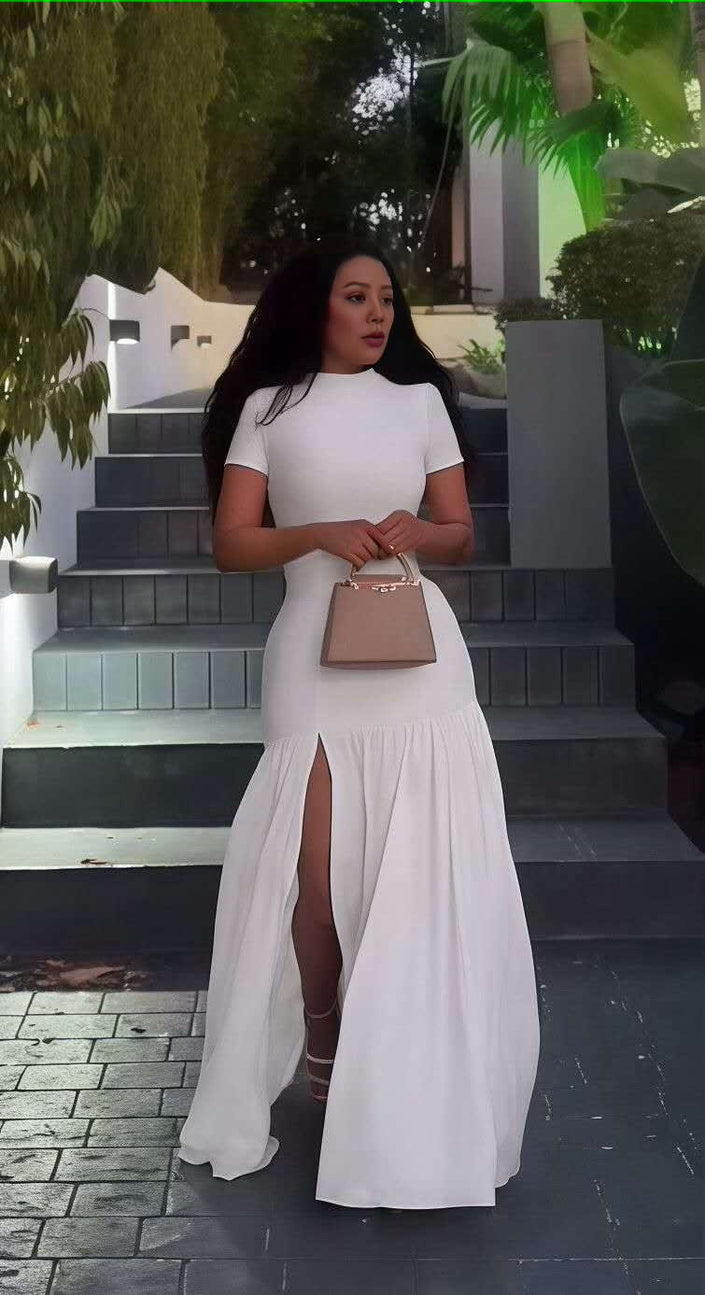 White maxi dress with short sleeves, fitted bodice, flared A-line skirt and high slit