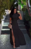 Black maxi dress with short sleeves, fitted bodice, A-line skirt and high slit