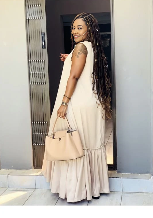 Ivory sleeveless maxi dress with ruffle hem, tiered skirt