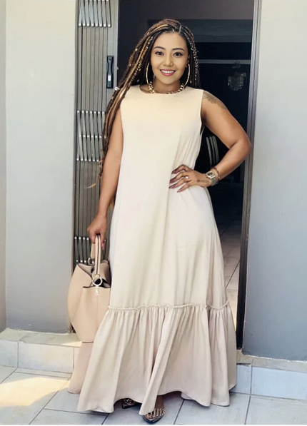 Cream sleeveless maxi dress with ruffle hem and gathered tier