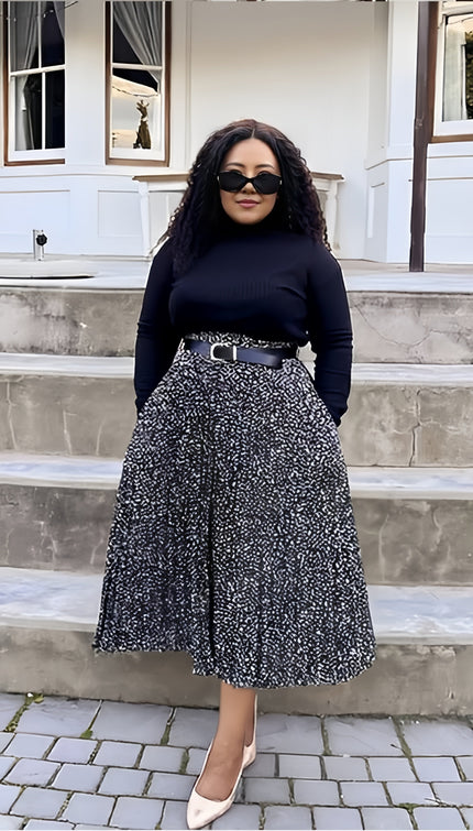Pleated midi skirt with black-and-white speckled pattern, elastic waistband and belt