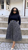 Pleated midi skirt with black-and-white speckled pattern, elastic waistband and belt