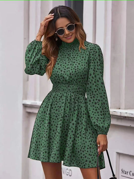 Dark-green dotted mini dress with puff sleeves, high neckline, and elastic waist