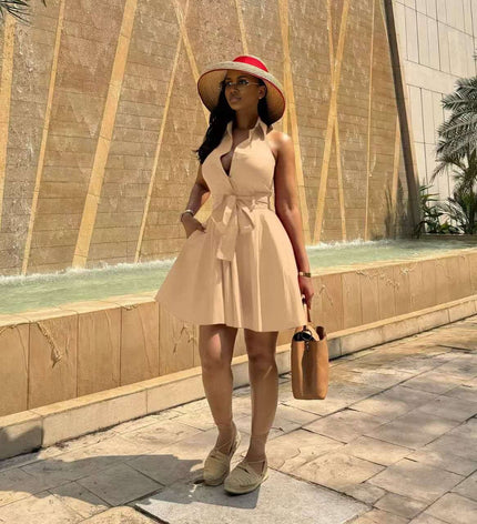 Nude sleeveless tie-waist A-line dress with halter neckline and flared skirt