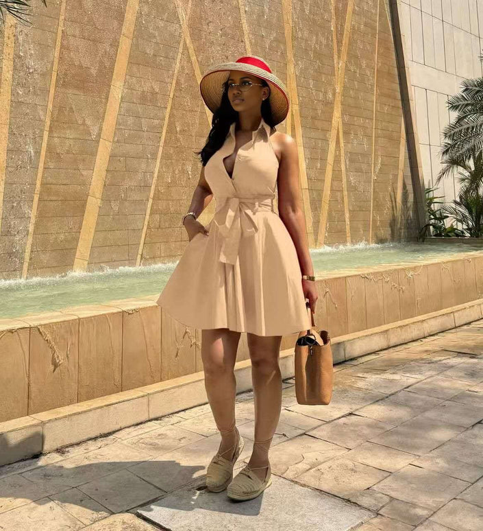 Nude sleeveless tie-waist A-line dress with halter neckline and flared skirt
