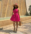 Hot-pink sleeveless tie-waist A-line dress with halter neckline and flared skirt