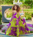 Maxi dress with purple and green floral print, spaghetti straps, tiered skirt.