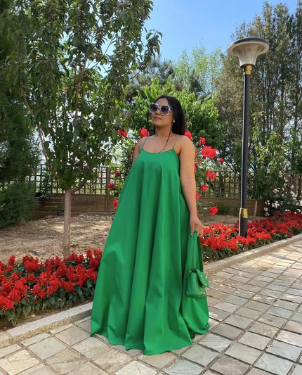 Green maxi dress with adjustable spaghetti straps, sleeveless, gathered flared skirt