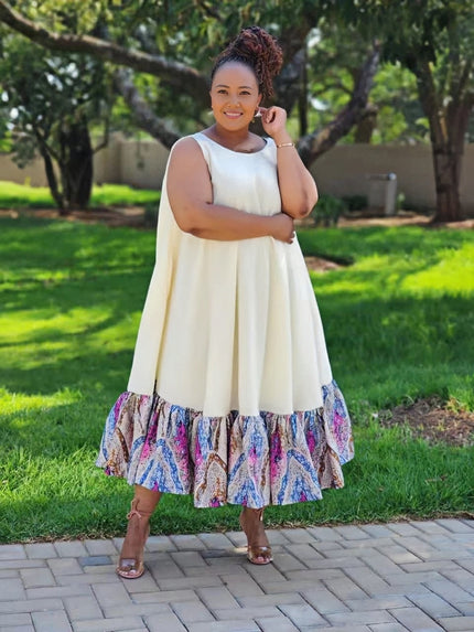 Plus-size sleeveless midi dress with ruffle hem; cream bodice, multicolor floral skirt