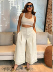 Beige pleated wide-leg culottes with stretch waistband and button detail