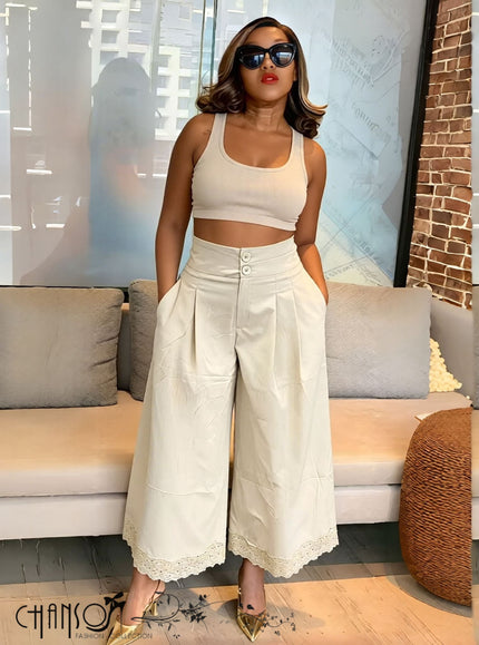 Beige pleated wide-leg culottes with stretch waistband and button detail