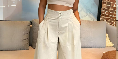 Beige pleated wide-leg culottes with stretch waistband and button front